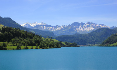 Lake Lungeren and mountain range. Early summer in Switzerland.
