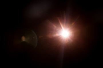 Abstract Natural Sun flare on the black background.