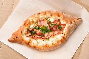 Fresh pastries, pie with bacon and cheese close-up, top view.