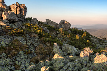 the rock against the blue sky in the rays of dawn