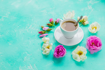 Fototapeta na wymiar morning cup of coffee and fresh beautiful pink and white roses flowers ,flat layout, copy space.Coffee drink concept with cup of americano and roses on concrete background.Morning feminine background