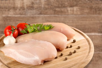 Raw Meat slices and knife on cutting board