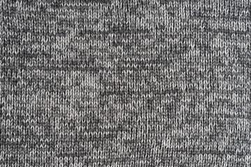 Texture knitted fabric. Warm sweater made of different color yarn. Creative vintage background.