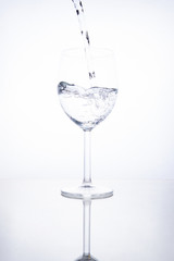 The glass is filled with clear transparent water.
