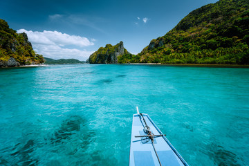 Boat trip to tropical islands El Nido, Palawan, Philippines. Steep green mountains and blue water...