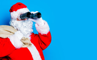 Funny Santa Claus have a fun with binoculars