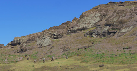 Fototapeta na wymiar AERIAL: Moai statues are scattered around the inside of the Rano Raraku volcano.
