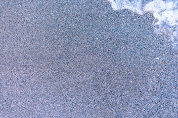 Sand on the sea beach and waves of sea water. Creative vintage background.