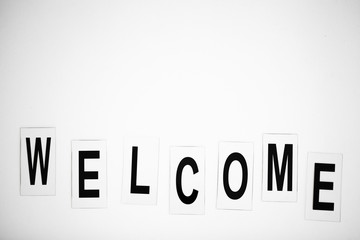 Welcome word written on white table. Copy space
