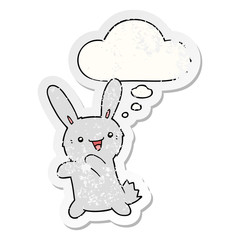 cartoon rabbit and thought bubble as a distressed worn sticker