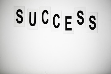 Success word written on white table. Copy space
