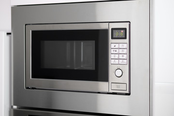 Close up of modern microwave oven front view grey color. Contemporary kitchen equipment necessary object in our life convenient easy usage, no people indoors