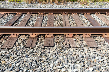 close up of section of the railway road with rusted on a sunny day