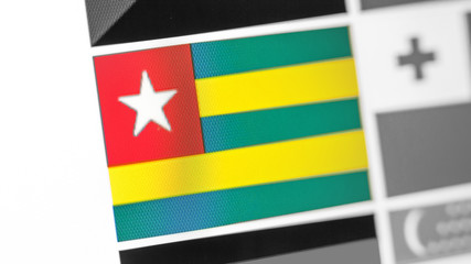 Togo national flag of country. Togo flag on the display, a digital moire effect.