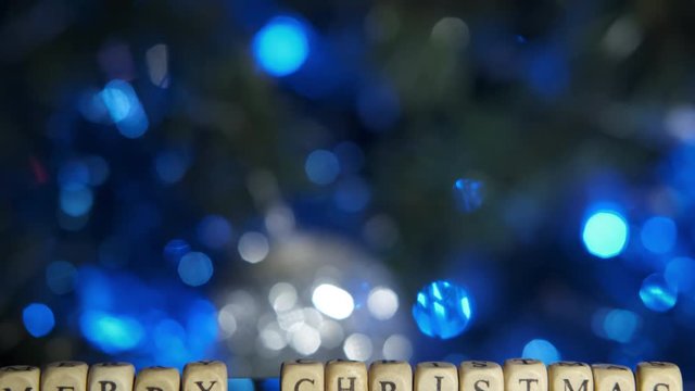 A merry christmas and tree. The inscription on the background of Christmas lights on the tree Merry Christmas.