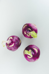 Fresh kohlrabi on white background. Group of raw organic purple turnip cabbage ready to eat.