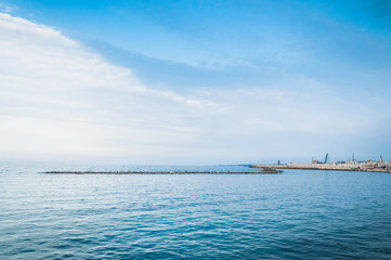 Calm sea in the evening with cloudy sky on the background