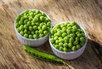Green peas in white bowl. Natural snacks.