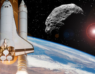 Rocket above earth. Asteroid in outer space. The elements of this image furnished by NASA.