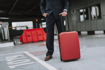 Businessman in suit is waiting on parking