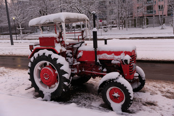 old tractor coverd in snow