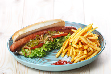 Hot dog with French fries and sauce