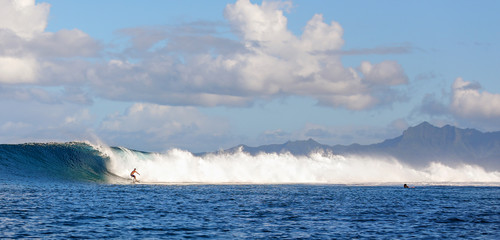 Young man surfing the break in Bora Bora, Tahiti. 