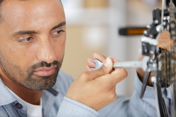 man repairing bicycle at home