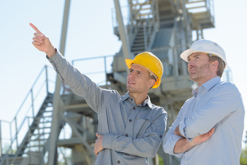 portrait of workers pointing horizon