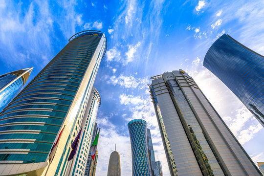 Low angle view of Al Fardan Towers complex and Doha Tower, iconic glassed high rises in West Bay, Doha, Qatar