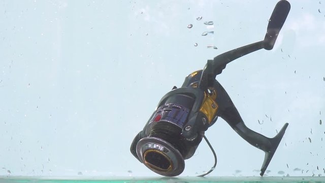 Fishing tackle slow motion. Beautiful idea on the theme of fishing and recreation. The concept of fishing sports and recreation.