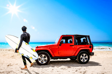 Fototapeta na wymiar Summer red car on beach and sea landscape with blue sky and sun . 
