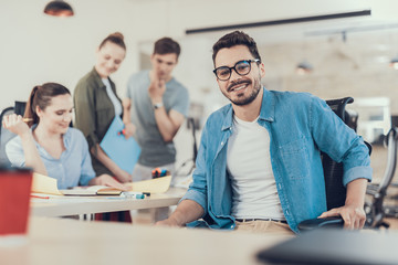 Smiling young man working with startup project in office