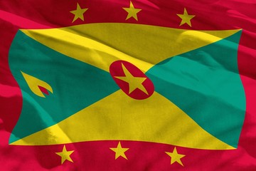 Waving Grenada flag for using as texture or background, the flag is fluttering on the wind
