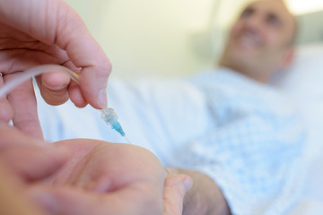 plastic surgeons hand holding syringe for injection
