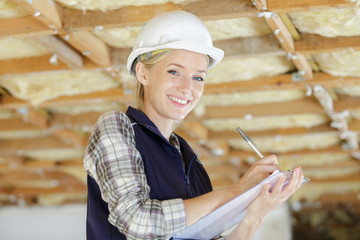 portait of a woman builder holding clipboard