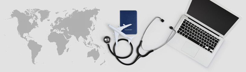 international medical travel insurance concept, stethoscope, passport, laptop computer and airplane...