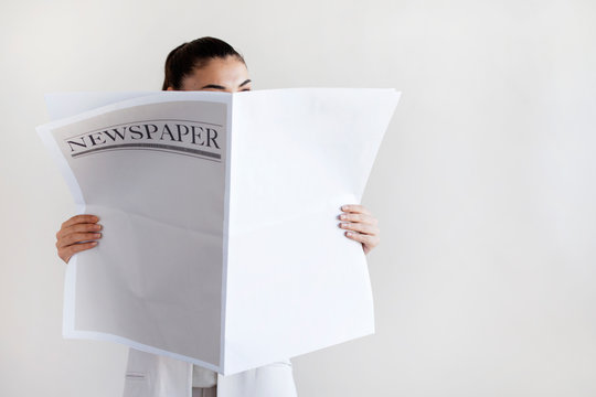 Woman Reading Newspaper On White Background