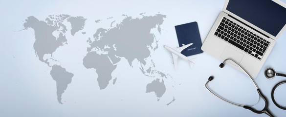 international medical travel insurance concept, stethoscope, passport, computer laptop and airplane...