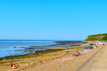 Mixture of young and old, teenagers, couples and families on a day trip to the relaxing Herne Bay beach. Herne Bay Beach, Kent, UK