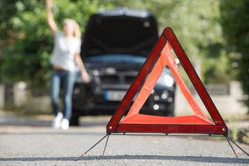 broken down car with warning triangle