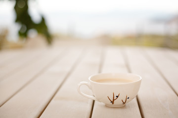 cup of coffee on wooden table
