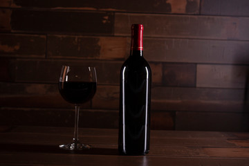 Luxurious scene enters bottle wood with red wine next to a glass served in Mexico