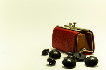 old red purse with black buttons white background