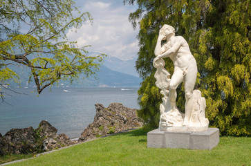 BELAGGIO, ITALY - MAY 10, 2015: The statue of Apollo in gardens of Villa Melzi by G. Della Porta from 16. cent.
