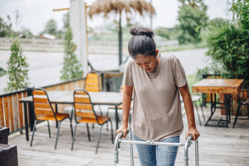 Young women using a walker cane during rehabilitation,medical and orthopedic concept,Healthcare and...