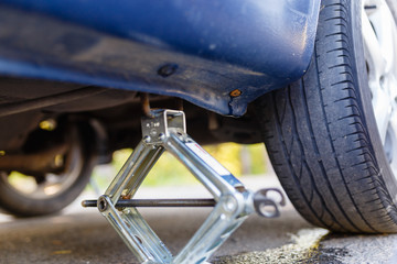 Closeup of metal keeps the car Jack to change a flat tire