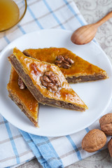 Traditional Arabic dessert. Baklava with walnuts, cardamom and honey. Homemade Turkish pastries.