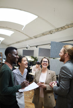 Portrait Of Multi -ethnic Group Of Business People Laughing Happily While Chatting During Coffee Break In Office, Copy Space