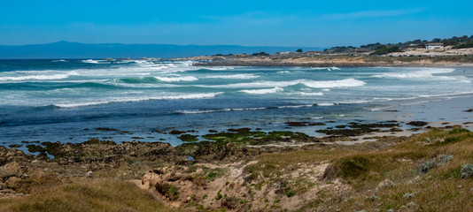 Waves break along the rocky coastal shores of the Monterey Bay, at Asilomar Beach, in Pacific Grove, along the central coast of California, close the the Big Sur coast and Highway 1.